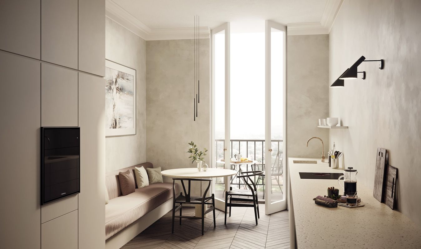 Petite cuisine d’appartement parisien équipée d’un four vapeur BORA X BO et d’une table S Pure, coin repas et porte-fenêtre