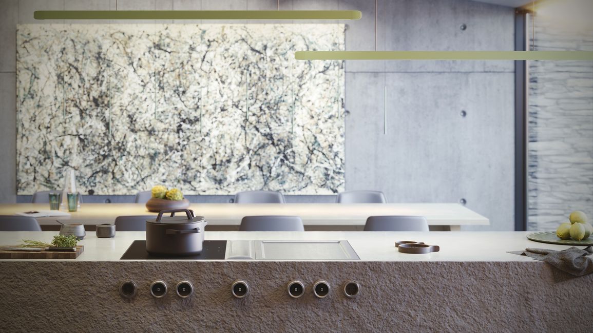 Table BORA Professional 3.0 mate à boutons inox, dans une cuisine en béton sous une grande toile abstraite