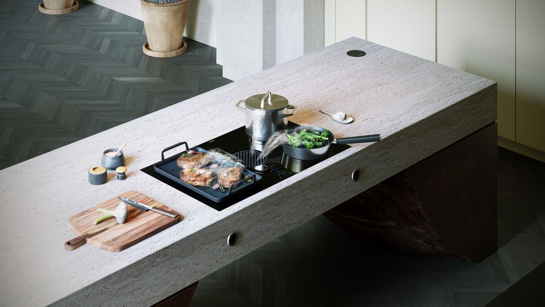 Table de cuisson aspirante BORA X Pure, viande en cuisson sur un îlot en travertin