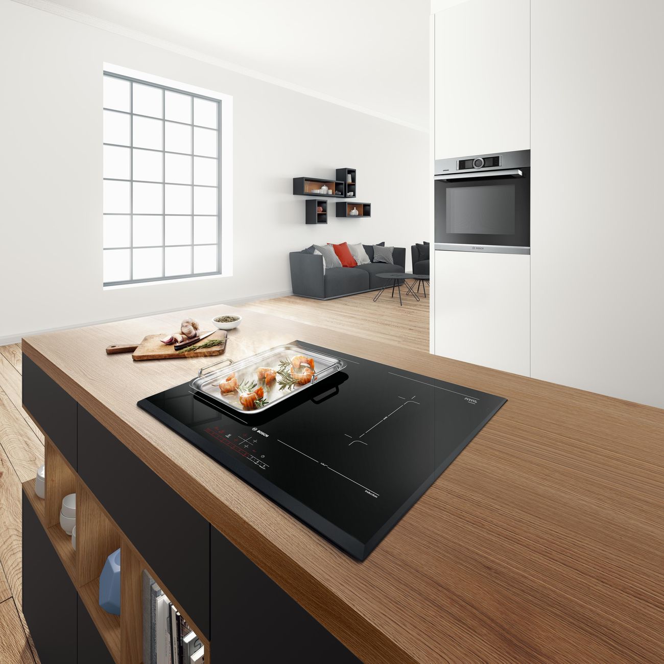 Table induction aspirante Bosch Série 8 sur un plan en bois, four encastré en colonne