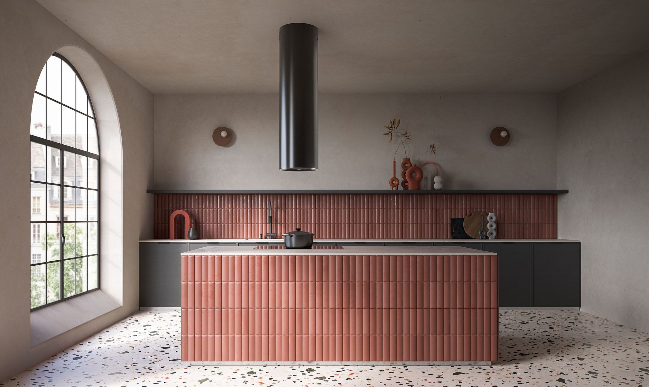 Hotte cylindrique Falmec Polar Evo noire au-dessus d’un îlot en céramique terracotta